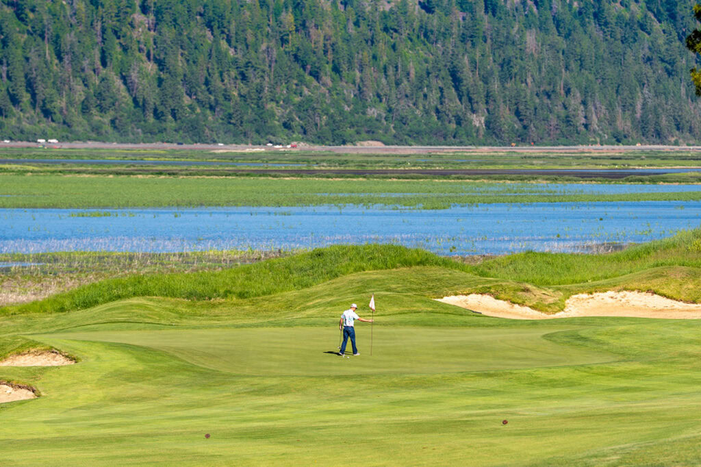 Secluded golf course at Running Y Resort with scenic mountain views and lush greens.