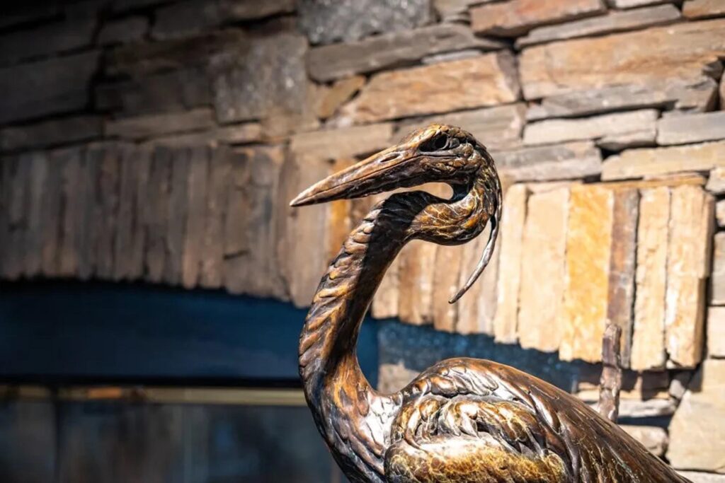 Intricate bronze heron sculpture at Running Y Resort, showcasing unique wildlife art and nature-inspired decor.