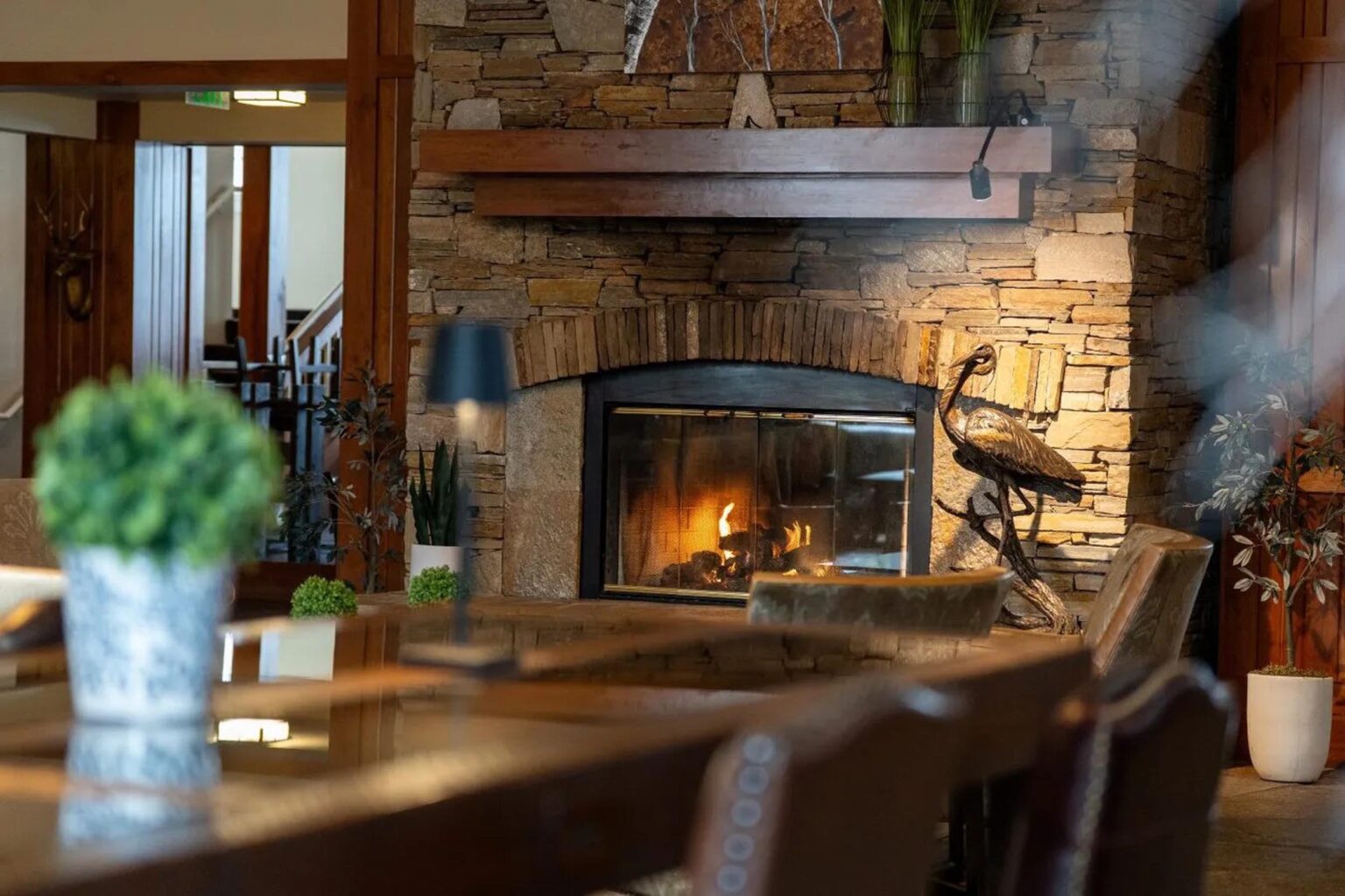Cozy lodge fireplace at Running Y Resort with rustic stone design and decorative wood accents.