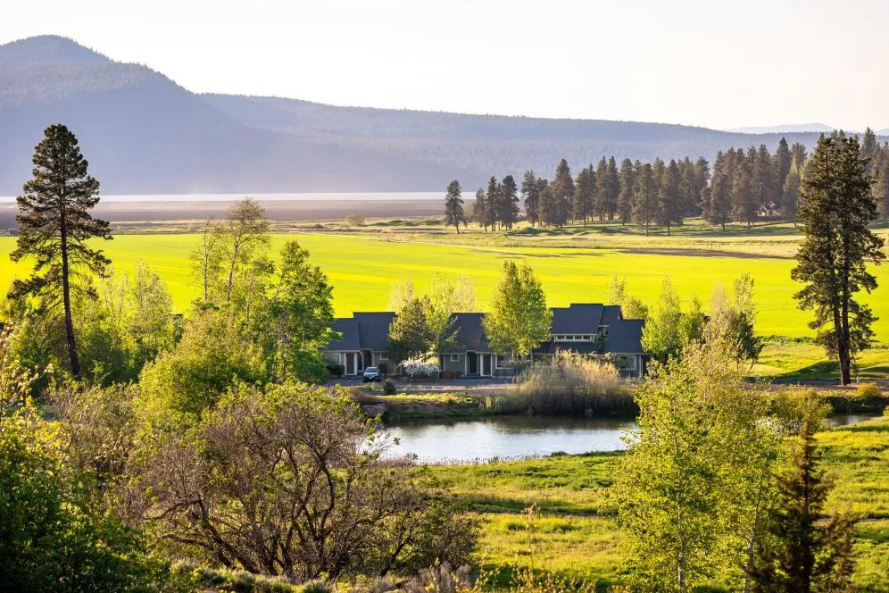 Serene landscape at Running Y Resort with lush greenery and mountains in the background.