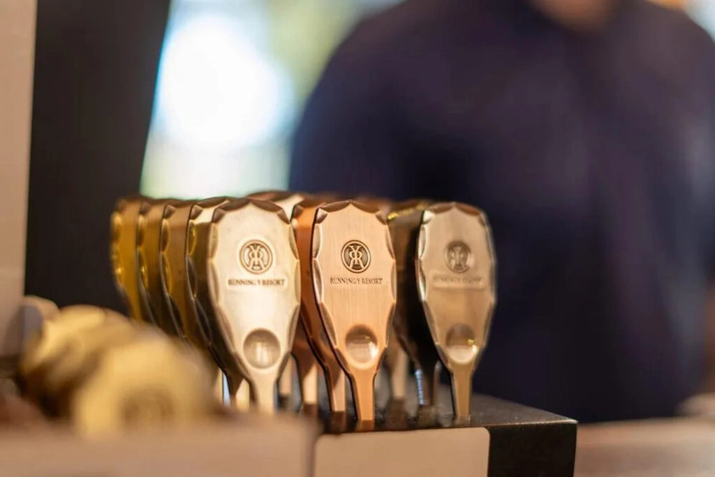 Luxurious golf divot tools featuring the Running Y Resort logo for upscale outdoor activities.