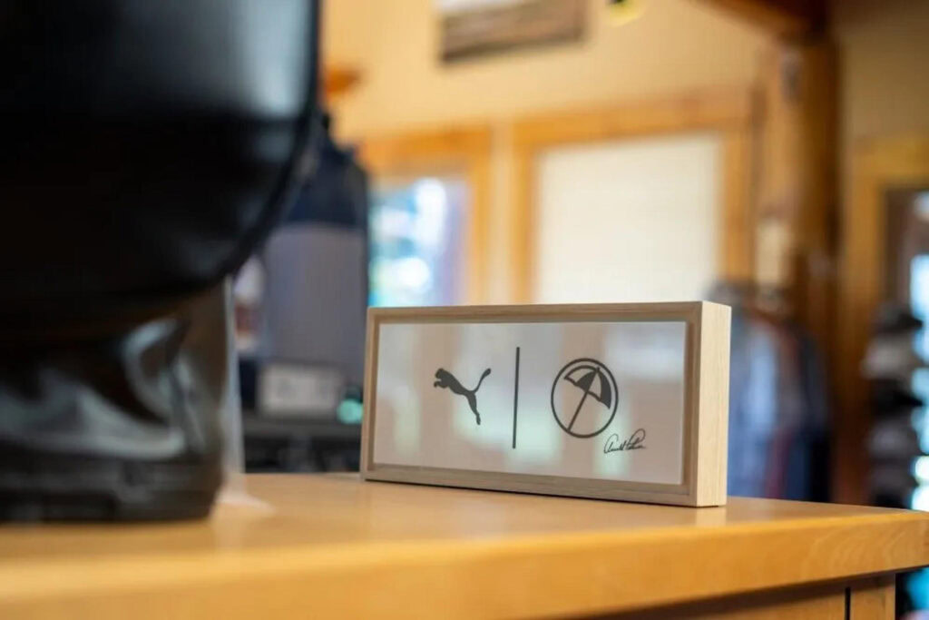 Puma logo and outdoor activity icons on a sign at Running Y Resort, Oregon.