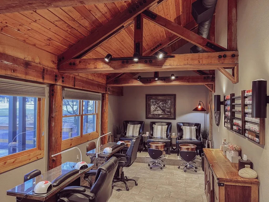 Cozy nail salon interior with wooden accents and comfortable seating, perfect for relaxation.