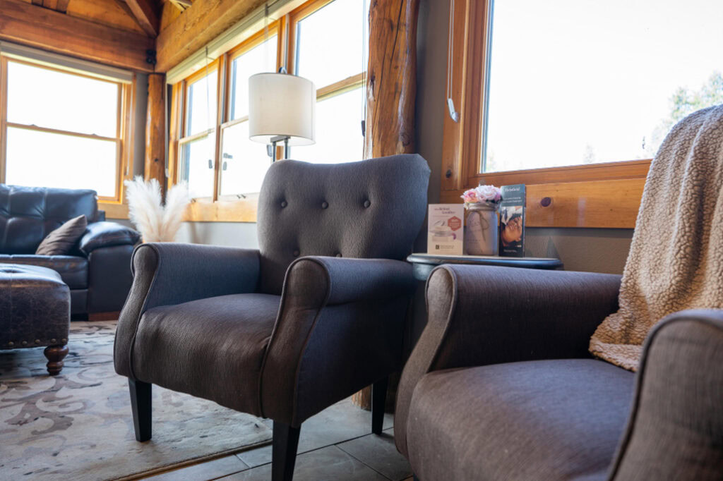 Cozy interior of Running Y Resort with comfortable armchairs and rustic wooden accents.