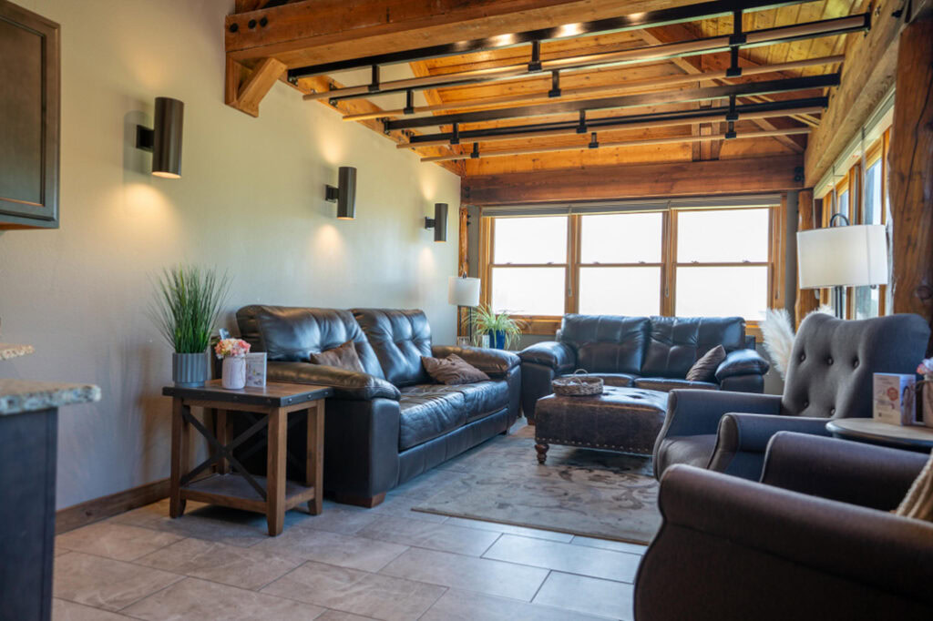 Cozy lodge living room at Running Y Resort with leather sofas and natural wood accents.