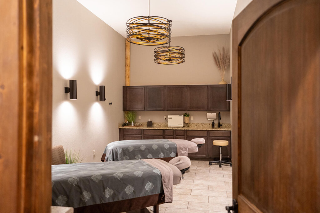 Cozy spa treatment room at Running Y Resort with massage beds and modern decor.